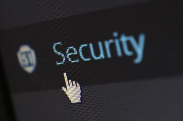 Cursor pointing to security option on computer screen with security shield icon visible