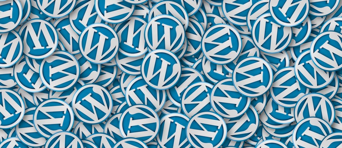 Moving WordPress – A Comprehensive Guide! Pile of overlapping blue and white WordPress logo badges filling the entire image background.