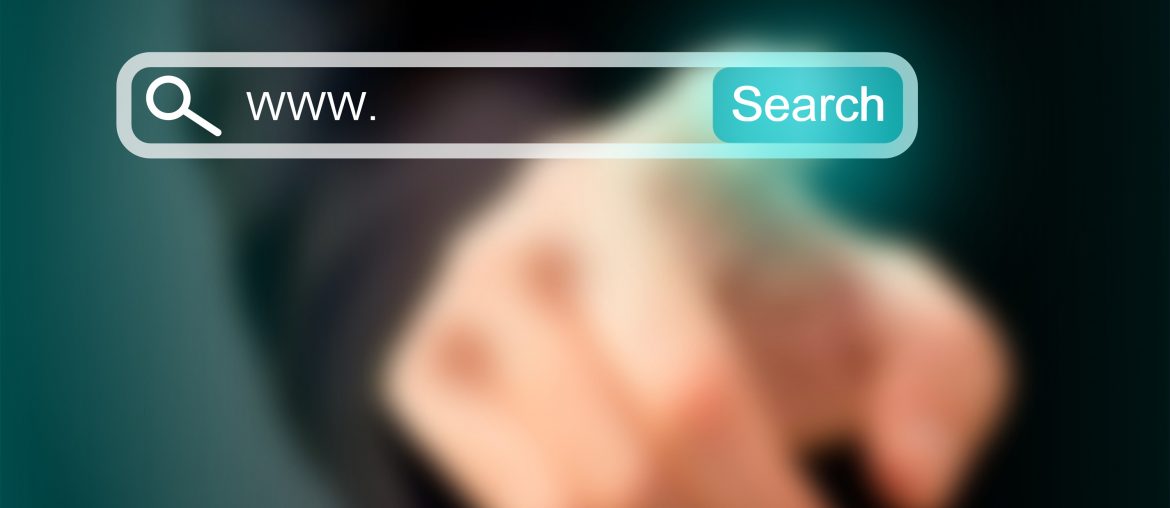 What Is a Premium Domain and Is It Worth Getting One? Hand pointing at virtual search bar with www. and Search button on dark background.