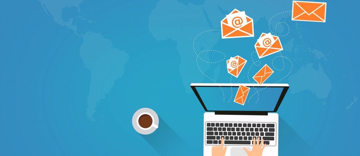 My Emails are Flagged as Spam, What Can I Do? Illustration of a person typing on a laptop with emails flying out above a blue world map background with coffee cup nearby.