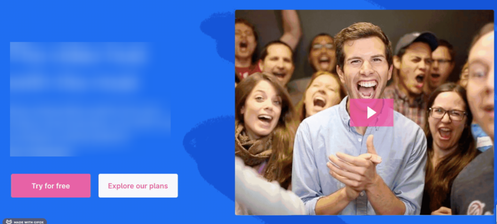 Group of excited people cheering with a central man clapping, play button overlay, blue and pink background.