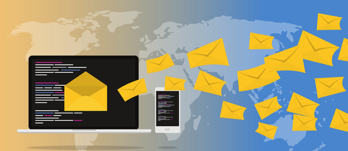 A laptop and a smartphone, with dozens of envelopes flying around them